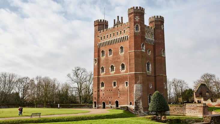 A view of the east and north fronts of the Great Tower at Tattershall Castle, Lincolnshire, with the moat in the foreground